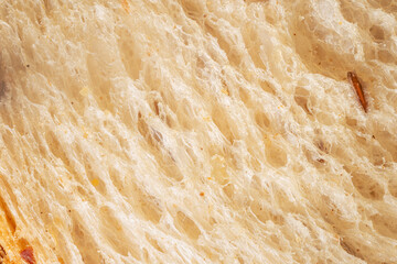 A close-up of a slice of White bread, showing the texture of the airy baked bread