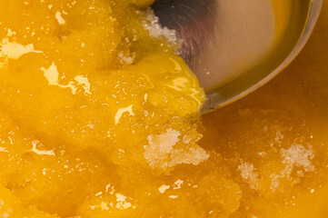 Two ingredients, egg yoke and sugar, close up for making a creme brulee dessert