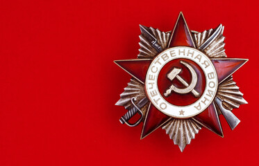 Soviet Order of the Patriotic War on a red background. Symbol victory in World War II. Translation...
