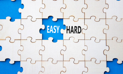 Easy or Hard symbol. Concept word Easy or Hard on wooden puzzle. Beautiful blue background. Business and Easy or Hard concept. Copy space