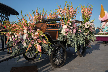 A carriage decorated with flowers. The annual International Flower Festival in St. Petersburg