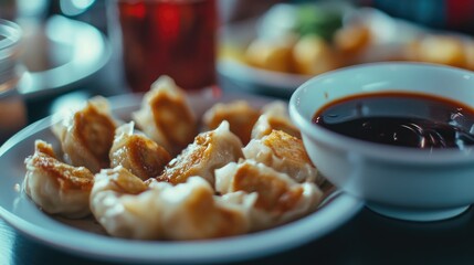High contrast lighting illuminating golden edges of crispy dim sum next to soy sauce bowl