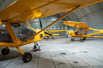 Yellow airplane glider in the hangar. 