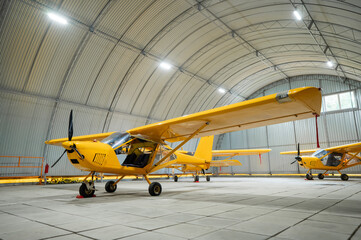 Yellow airplane glider in the hangar. 