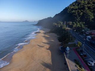 Amazing lighting on orange sand beach and strong waves in coastal village