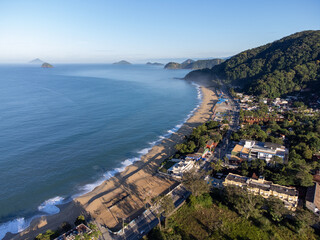 Amazing lighting on orange sand beach and strong waves in coastal village
