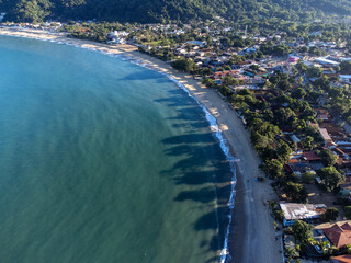 Amazing lighting on orange sand beach and strong waves in coastal village
