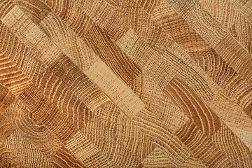 Oak wooden board as background, top view. Cross section of tree trunk. Natural durable end grain hard wood cutting board.