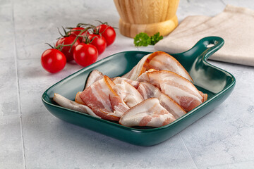 Raw pork tenferloin with bacon