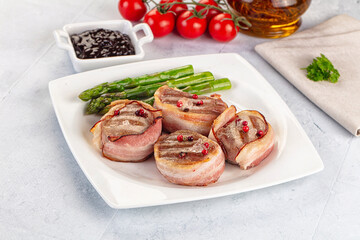 Tasty grilled pork medallion with bacon