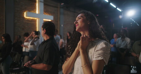 Congregation members with joyful expressions, standing during a Christian church event, reflecting...