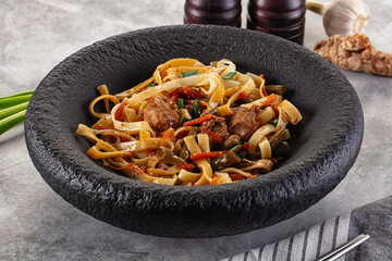 Asian cuisine udon with chicken and vegetables
