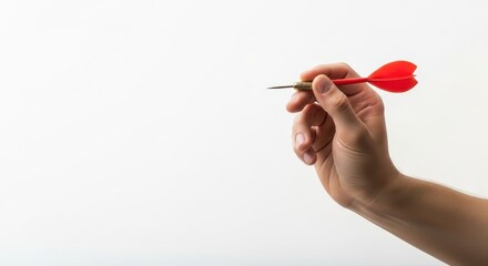 A hand of a man holding a red dart ready to throw on a white background. Aiming for an accurate target. Achieving goal concept.