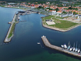 Aerial view of Ebeltoft harbor with boats, piers, and coastal townscape