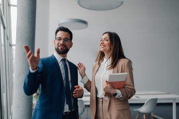 Business partners discussing new project in modern office space