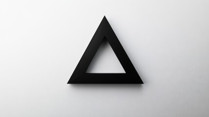 A bold black triangular shape is centered against a minimalist white background, creating a striking visual contrast. The design emphasizes simplicity and geometry, inviting contemplation.
