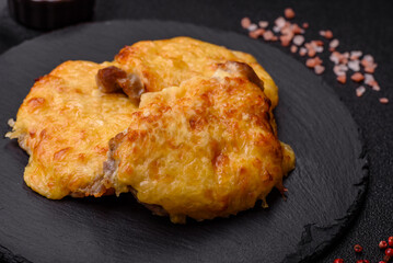 Steak, a pork or chicken chop covered with melted cheese. Grilled meat