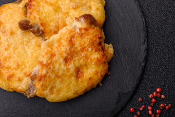 Steak, a pork or chicken chop covered with melted cheese. Grilled meat