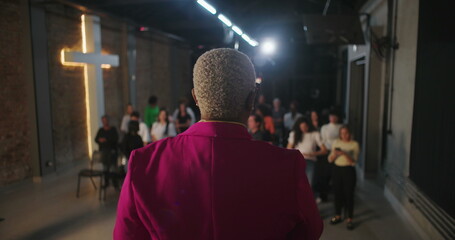 Pastor engaging congregation in worship, leading prayer with raised hands, spiritual connection in...