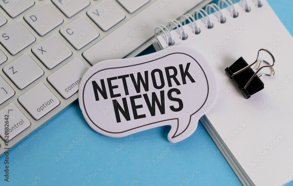 Poster a keyboard with a clip on it and a white piece of paper with the word network news written on it