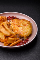 Fried French fries with a piece of meat, lunch food. Prepared potatoes and meat