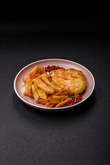 Fried French fries with a piece of meat, lunch food. Prepared potatoes and meat