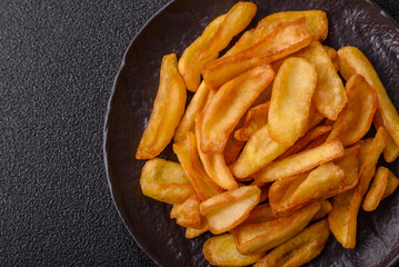 Fried crispy French fries with salt, spices, food for lunch