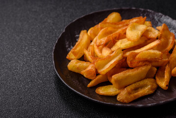 Fried crispy French fries with salt, spices, food for lunch