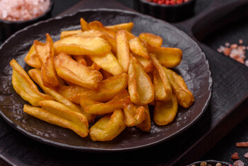 Fried crispy French fries with salt, spices, food for lunch