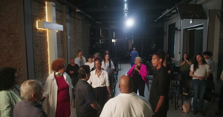 Congregation participating in prayer and worship, focused on spiritual connection, leader guiding service in modern evangelical church setting