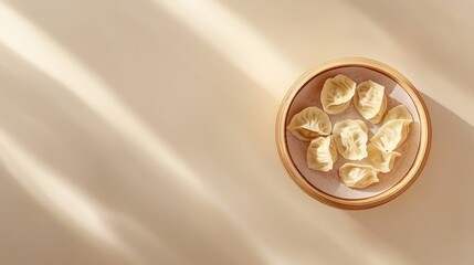 Minimalist background with centered bamboo steamer containing beautifully arranged dumplings