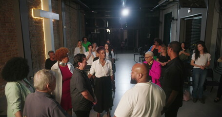 Congregation participating in prayer and worship, focused on spiritual connection, leader guiding service in modern evangelical church setting