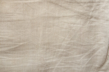 Fototapeta premium Natural beige linen fabric texture close-up, background for design