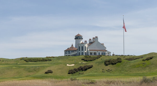 white building on green meadow grass hill next to american flag of the united states of america usa golf course next to hudson river bayonne new jersey - Powered by Adobe
