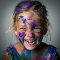A young girl with paint all over her face, laughing