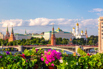 View of Moscow Kremlin, Moscow River and Big Stone bridge with pink flowers on the foreground during summer sunny day. Landmark in Moscow, Russia
