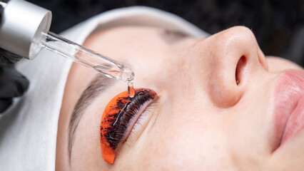 The process of professional lamination and tinting of eyelashes in the salon.