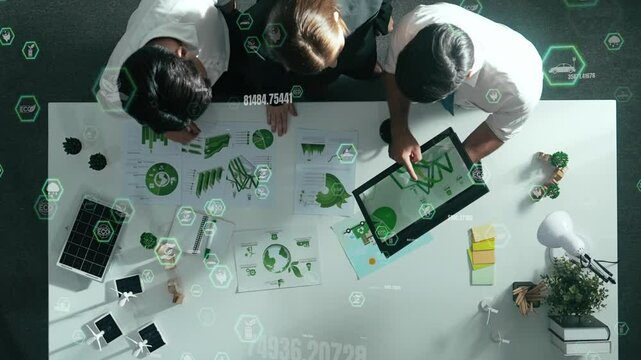 Top view of business team discussing about using clean energy and sustainable investment at meeting table with wind mill, document with environmental graph and holographic of eco power. Alimentation. - Powered by Adobe