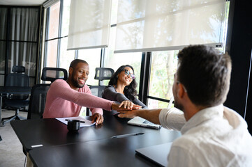 Multiracial Team Collaborating in Bright Modern Office with Smiling Professionals at Work