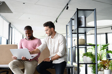 Young Diverse Professionals Collaborating in Bright Modern Office with Natural Light