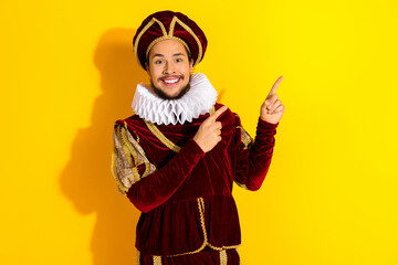 Cheerful Man in Noble Medieval Costume Performing on Yellow Background
