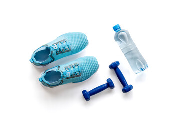 Flat lay of fitness sports equipment. Sneakers and dumbbells for gym. Wellness concept