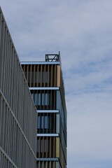 Modern architectural facade under a clear sky. Striking angles and clean lines dominate this urban composition.