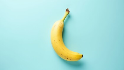 Banana on light blue background, top view