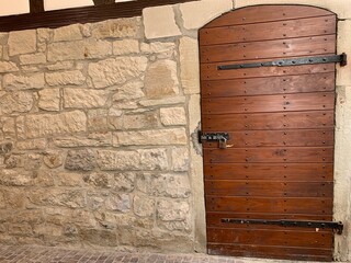 An aged wooden door in a stone wall, showcasing rustic German architecture