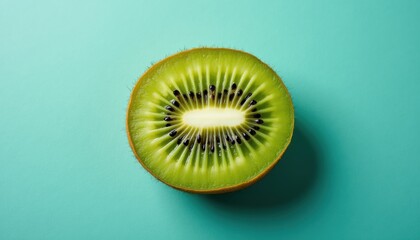 Kwi slice on teal background, top view