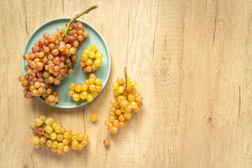 Many fresh green grape clusters isolated, top view