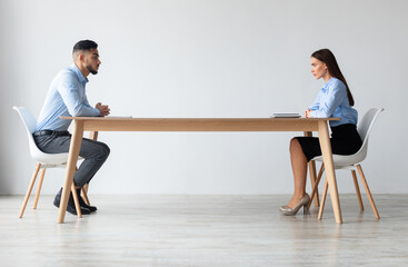 Plakat Interview, Business Meeting Concept. Profile side view of two serious people in formalwear sitting in front of each other at long desk in the office while discussing something, hr hiring staff