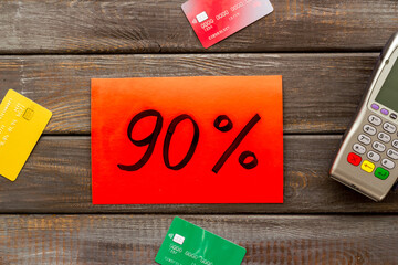 Sales with discount percentage sing concept. Online shopping. Top view of a POS payment terminal and credit cards