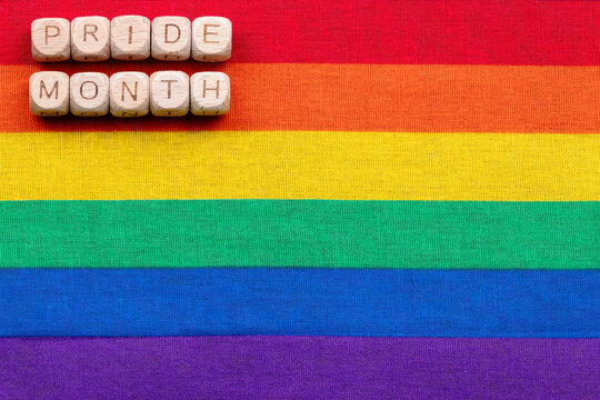 Pride month celebration with vibrant rainbow colors and wooden blocks
